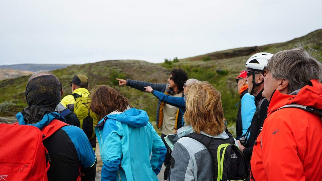 Group of tourist bikers listening to the guide